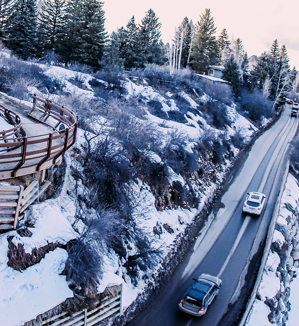Cars climbing hill under Castle Creek bridge